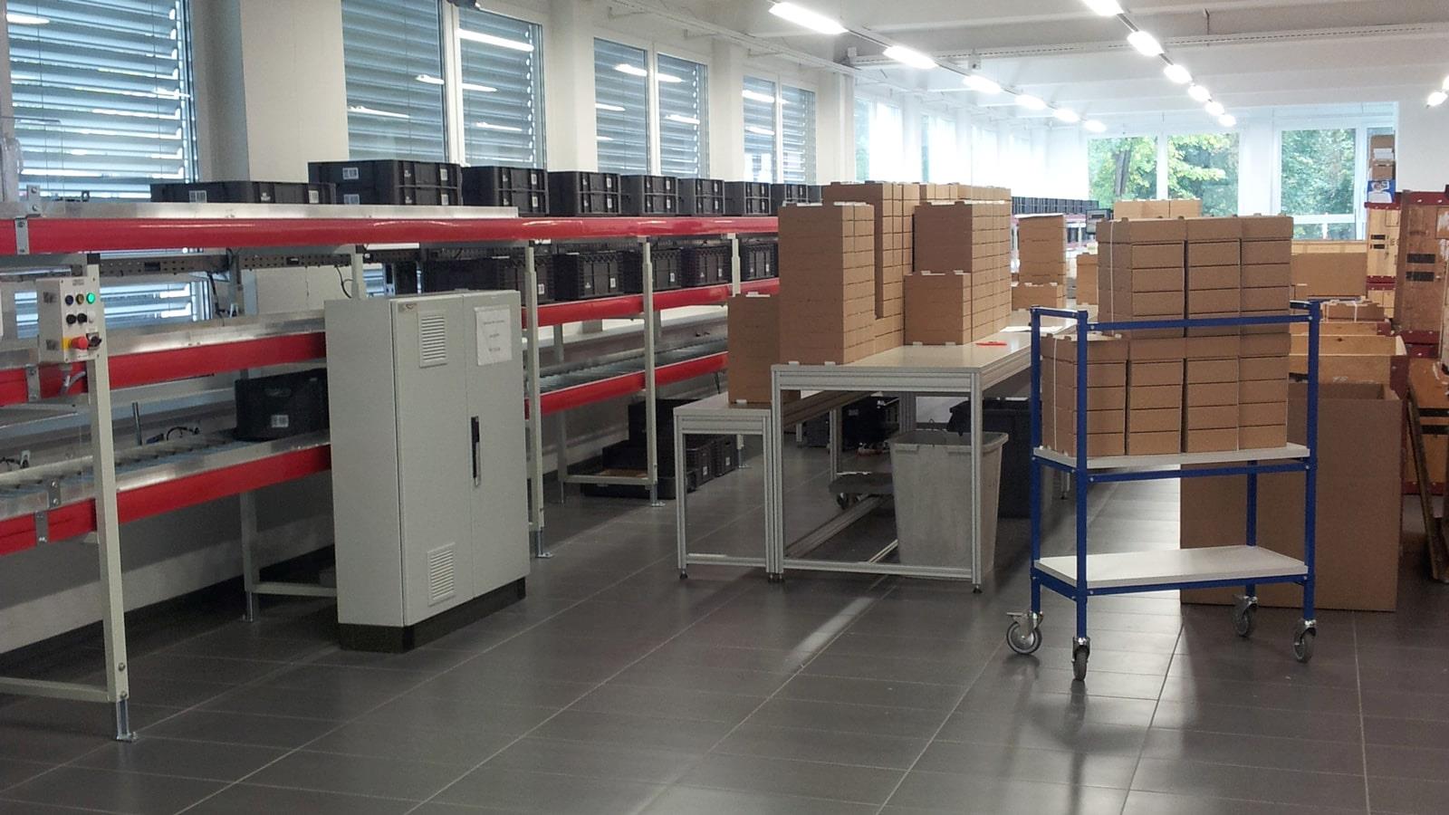 Stacks of cardboard boxes in production hall of Swiss tissot